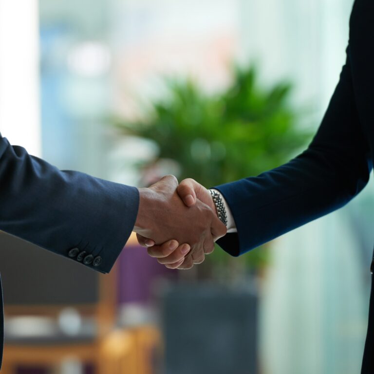 business people shaking hands to confirm deal
