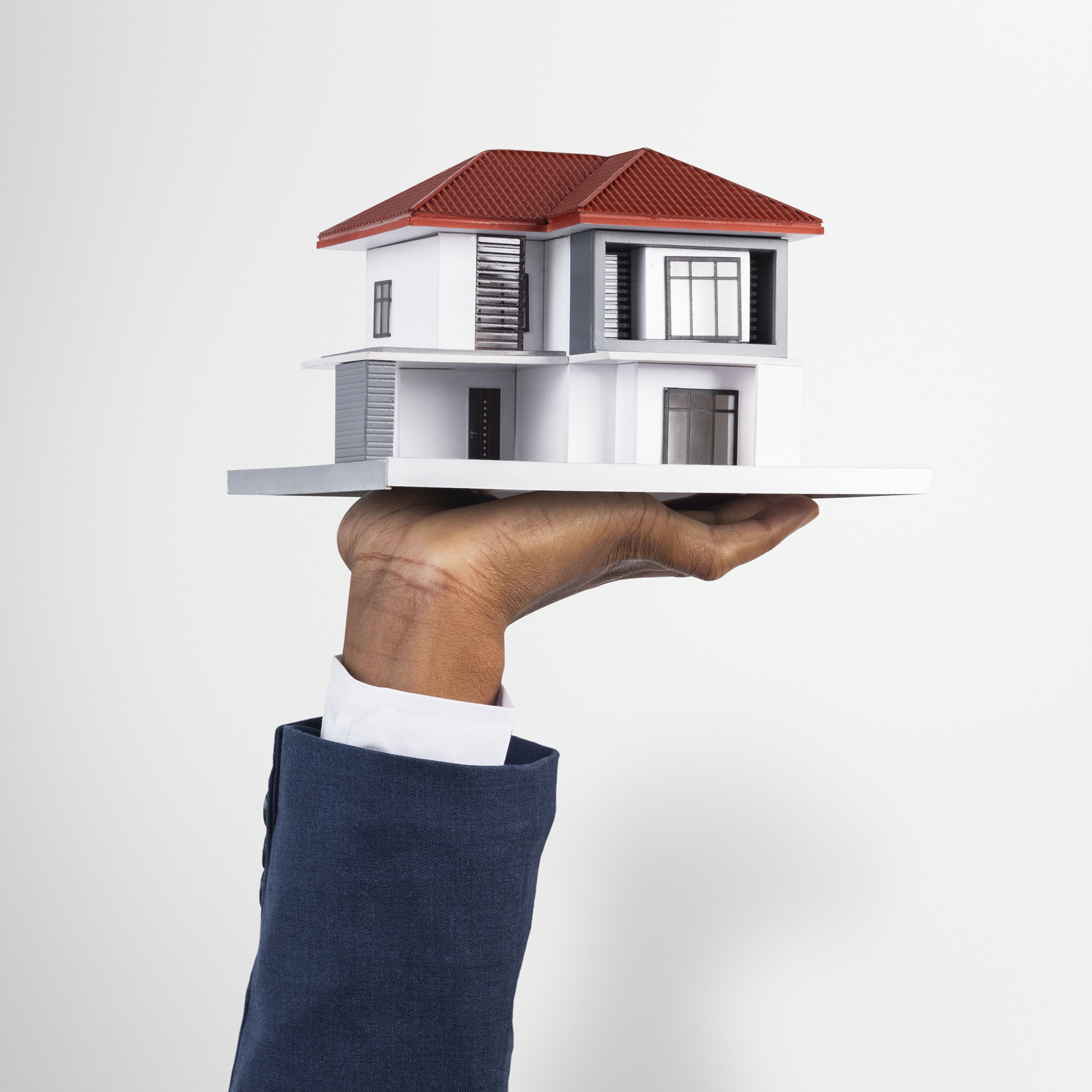 hand holding house real estate and property model