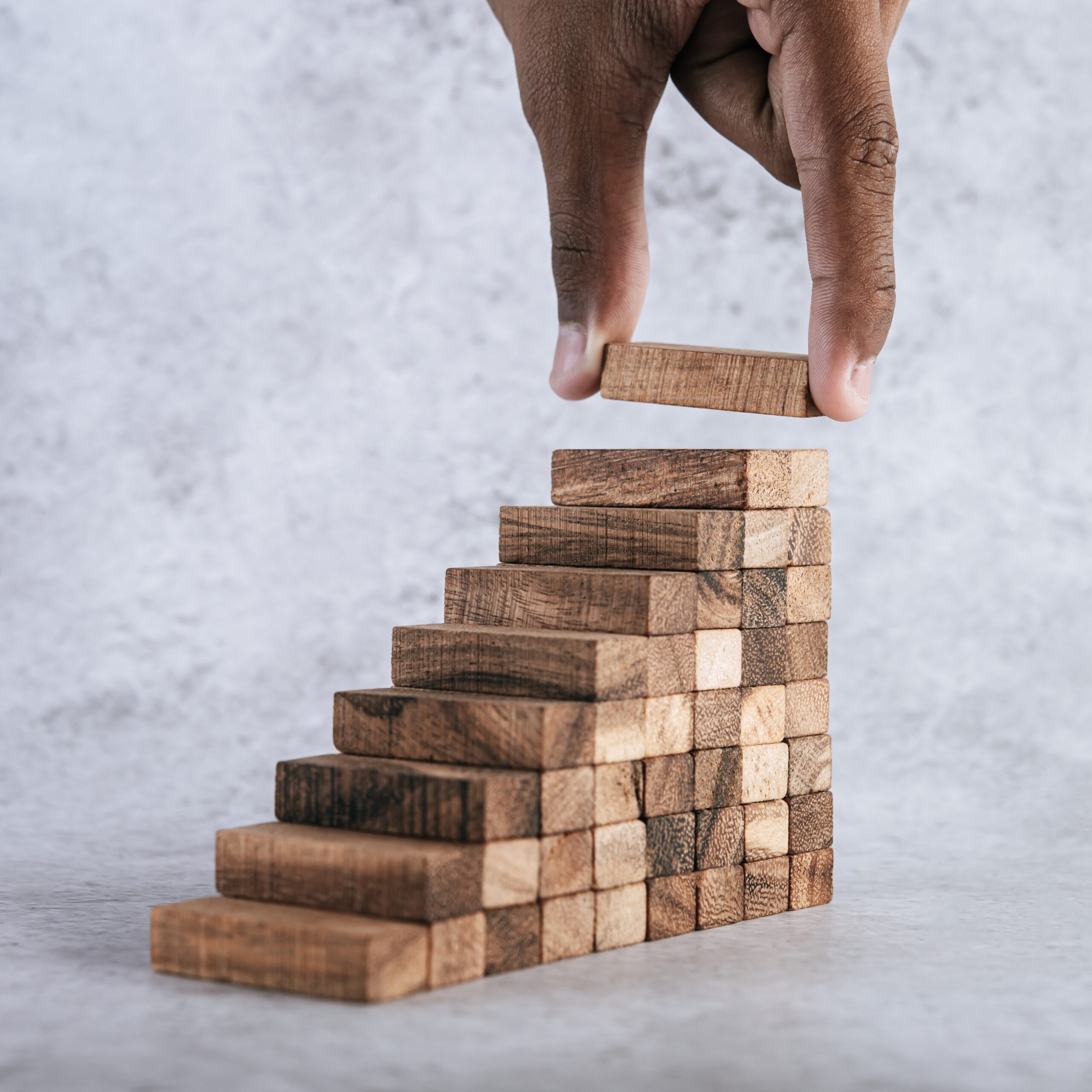 stacking wooden blocks is at risk in creating business growth ideas.